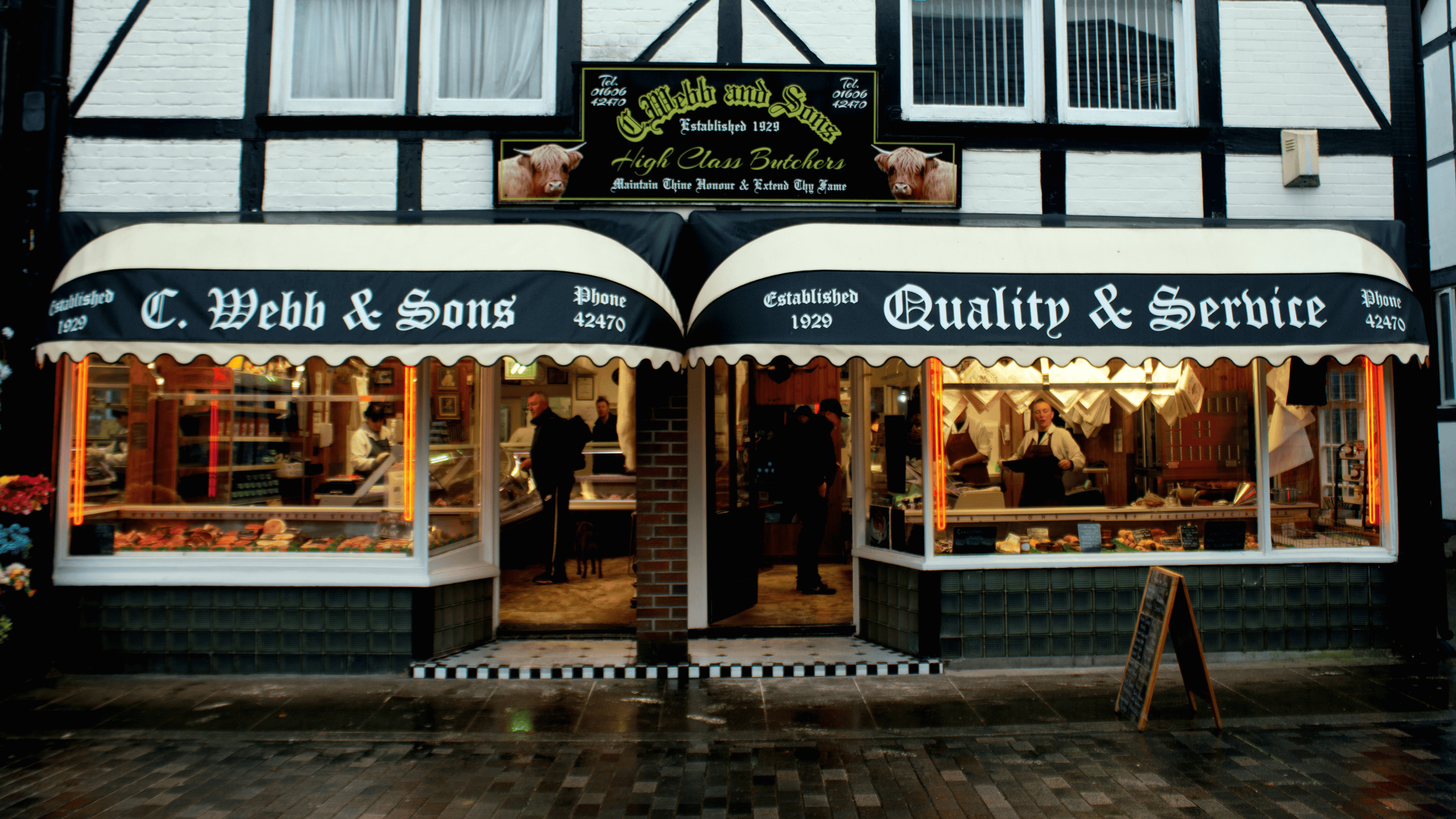 A lanscape image of the whole front of C Webb and Sons Butchers shop.
